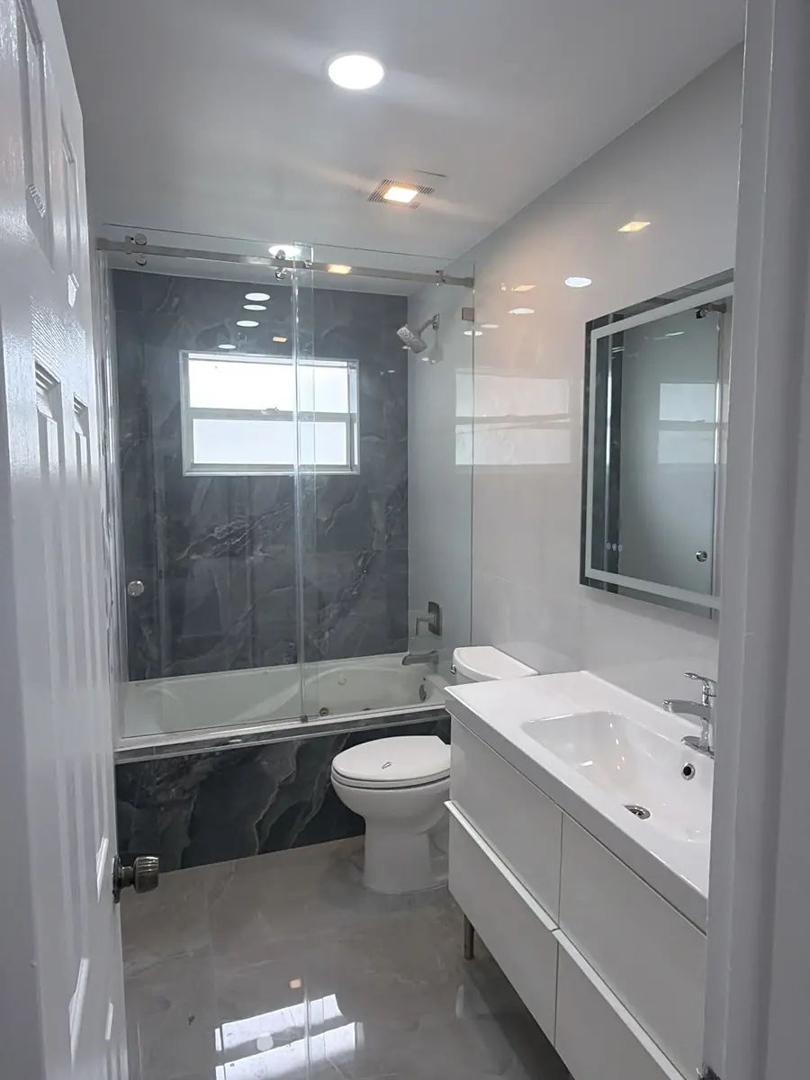 Bathroom: dated tile to modern spa - after