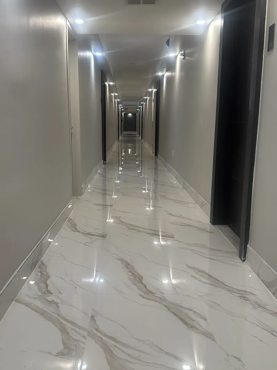 Condo hallway: old carpet to glossy large-format porcelain tile - after